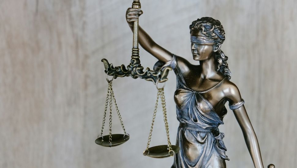 bronze statue of the scales of justice