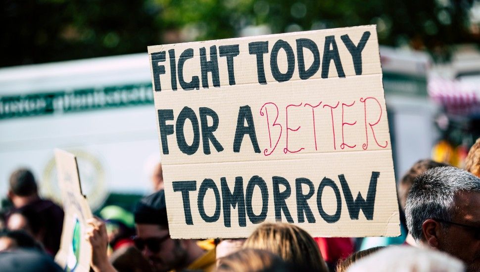 image of a sign at a protest. the sign reads "fight today for a better tomorrow."