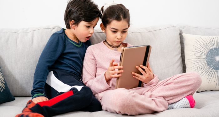 two children looking at a tablet